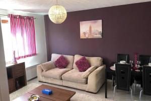a living room with a couch and a table at Beautiful Self-Catering 2 Bed Apartment with Free Parking 10 Minutes to City Centre in Edinburgh