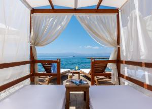 a room with two beds and a view of the ocean at Grand Hotel Ontur Cesme in Çeşme