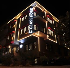a hotel with a neon sign on the side of it at Class Hotel Bosphorus With Jacuzzi in Istanbul