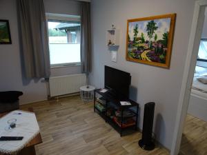 a living room with a flat screen tv on a wall at Ferienwohnung Ehmann in Schneverdingen