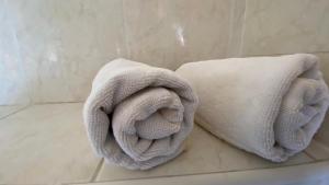 two towels sitting on the floor of a bathroom at Villa Osipovica in Medulin +45 photos