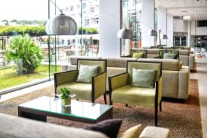 a lobby with couches and chairs and a table at Hotel Mediteran Plava Laguna in Poreč