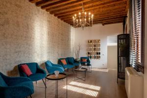 a room with blue chairs and tables and wine racks at La Finestra sulle Beccarie in Venice