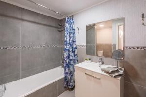 a bathroom with a tub and a sink and a shower at Aire del Mar in Port de Pollensa +12 photos