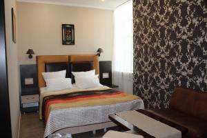 a hotel room with a bed and a couch at Hotel Atlantida in Kislovodsk