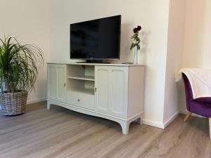 a white cabinet with a television on top of it at Ferienwohnung Birkenhof in Drolshagen