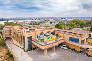 an overhead view of a building with a parking lot at Asmara Hotel in Lusaka