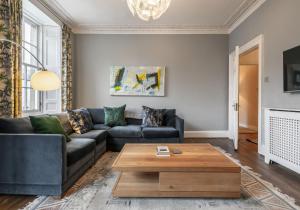 a living room with a couch and a coffee table at The St Patrick Square Residence in Edinburgh