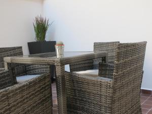 a wicker table and chairs in a room at Alhambra Hotel in London