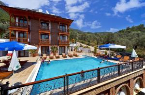 a hotel with a swimming pool on a balcony at Hotel Azmakhan in Akyaka