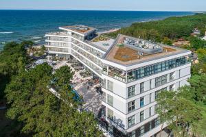 an aerial view of a building next to the ocean at Dune Resort Mielno - A in Mielno