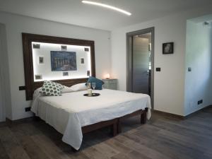 Schlafzimmer mit einem großen weißen Bett und einem Tisch in der Unterkunft HOTELLERIE VALLE SACRA in Cintano