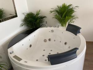 a white bath tub with plants in a room at Die Oase - Luxurious Apartment near the City Center with Free Parking in Bratislava