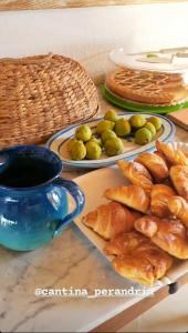 a table with plates of pastries and a cup of coffee at Cantina Perandria in Monti