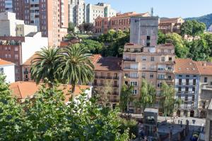 a view of a city with buildings and palm trees at Bilbao Sensations.OLD TOWN exclusive views&parking in Bilbao