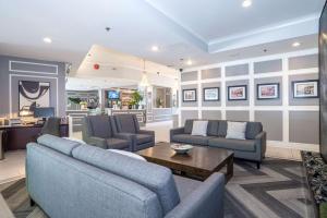 a living room with two couches and a table at Best Western Dorchester Hotel in Nanaimo