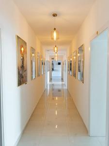 a corridor in a building with paintings on the walls at Litore in Pula
