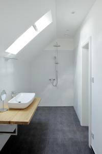 a white bathroom with a sink and a shower at Galerie Napoli in Bystřec