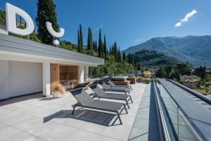 a row of lounge chairs sitting on a building at HOODY ACTIVE & HAPPINESS HOTEL in Arco