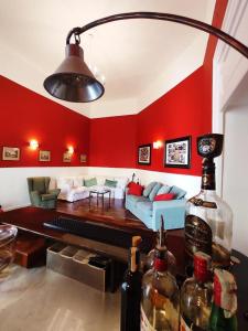 a living room with red walls and a bottle of wine at Palazzo Mirelli in Naples