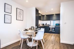 a kitchen and dining room with a white table and chairs at Host & Stay - Chavasse Chambers in Liverpool