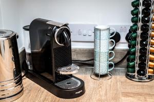 a black toaster sitting on a counter next to cups at Host & Stay - Chavasse Chambers in Liverpool