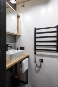 a bathroom with a sink and a mirror at Mount Apart Sport House in Zakopane +7 photos