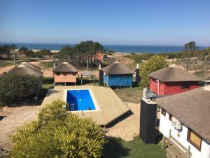 an aerial view of a house with a swimming pool at caribe in Punta Del Diablo