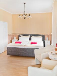 a bedroom with a large bed with red pillows at Pension Hanna in Bad Wilsnack
