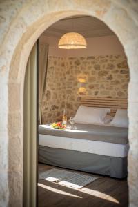 a bedroom with a bed and a sink in a room at Bellou Villas Sivota in Sivota