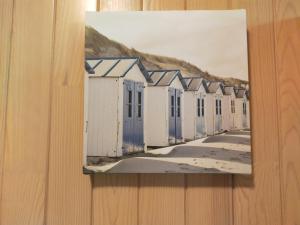 a painting of beach huts on a wall at La dépendance verte in Bordeaux