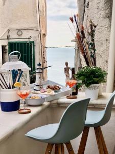 a table with a plate of food on a balcony at Casa Tua - Sea View Chianca in Vieste