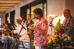 a group of men playing instruments at a party at Hotel Giulia in Lido di Camaiore