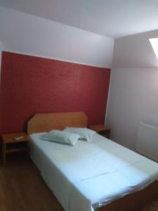 a bedroom with a white bed and a red wall at Vila Ana Lăcrămioara Concept in Căciulata +12 photos