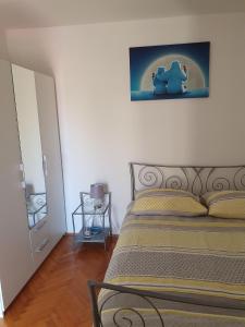 a bedroom with a bed with a picture of an elephant at Apartmani Adam in Primošten