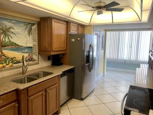 a kitchen with a refrigerator and a sink at Island House Beach Resort 16N in Siesta Key