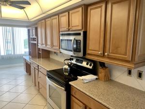 a kitchen with a microwave and a stove top oven at Island House Beach Resort 16N in Siesta Key