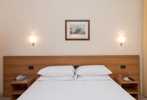 Postel nebo postele na pokoji v ubytování Hotel Casa Del Pellegrino