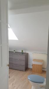 a living room with a toilet and a dresser at Bel appartement F2 centre ville in Le Havre +11 photos