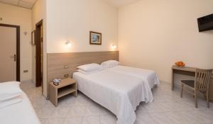 Postel nebo postele na pokoji v ubytování Hotel Casa Del Pellegrino