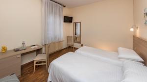 Postel nebo postele na pokoji v ubytování Hotel Casa Del Pellegrino