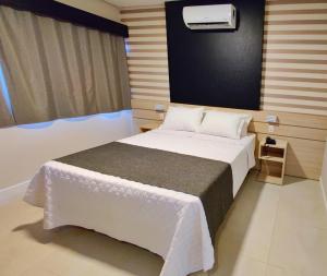 Postel nebo postele na pokoji v ubytování Mogano Express Hotel- ELETROPOSTO