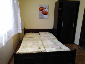 a bed in a bedroom with two pillows on it at Privat Mapak in Poprad