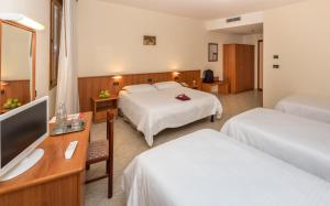 Postel nebo postele na pokoji v ubytování Hotel Casa Del Pellegrino