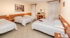 Postel nebo postele na pokoji v ubytování Hotel Casa Del Pellegrino