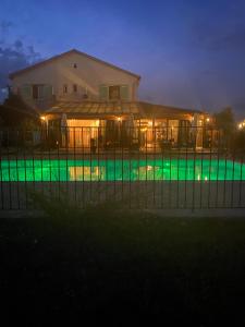 a house with a swimming pool at night at Le Plan B - Hôtel 3 étoiles - Restaurant in Ruoms