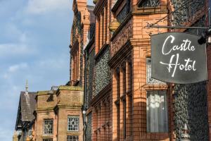 a building with a sign on the side of it at The Castle Hotel, Conwy, North Wales - The Coaching Inn Group in Conwy
