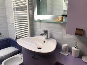 a bathroom with a sink and a toilet and a mirror at Casa di Debora in Perugia