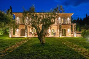 a large stone house with a tree in the yard at Bellou Villas Sivota in Sivota