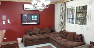 a living room with a couch and a tv at Mamora Beach Alexandria Egypt in Alexandria